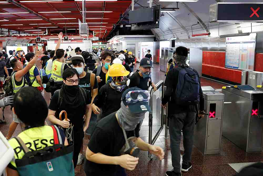 Anti-Extradition bill protesters run inside at Taikoo Shing Mass Transit Railway (MTR) station, after police detained protesters inside a station in Hong Kong August 11, 2019. u00e2u20acu201d Reuters pic