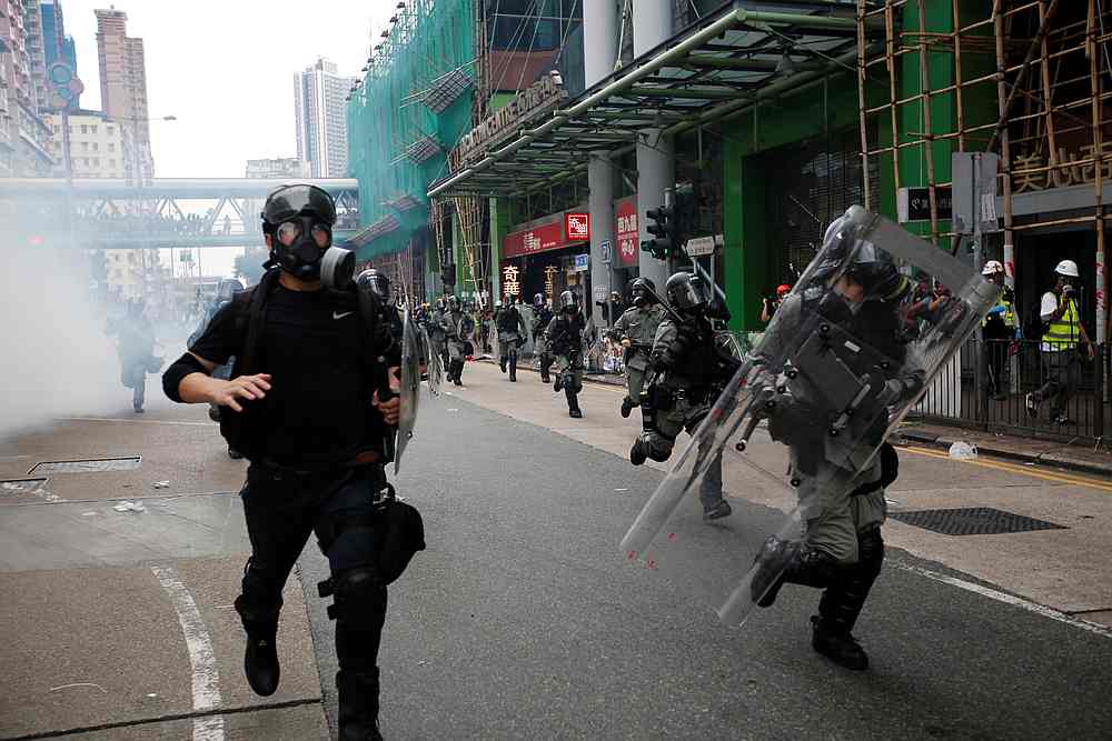 Police officers charge at protesters amid tear gas outside Sham Shui Po police station in Hong Kong August 11, 2019. u00e2u20acu201d Reuters pic