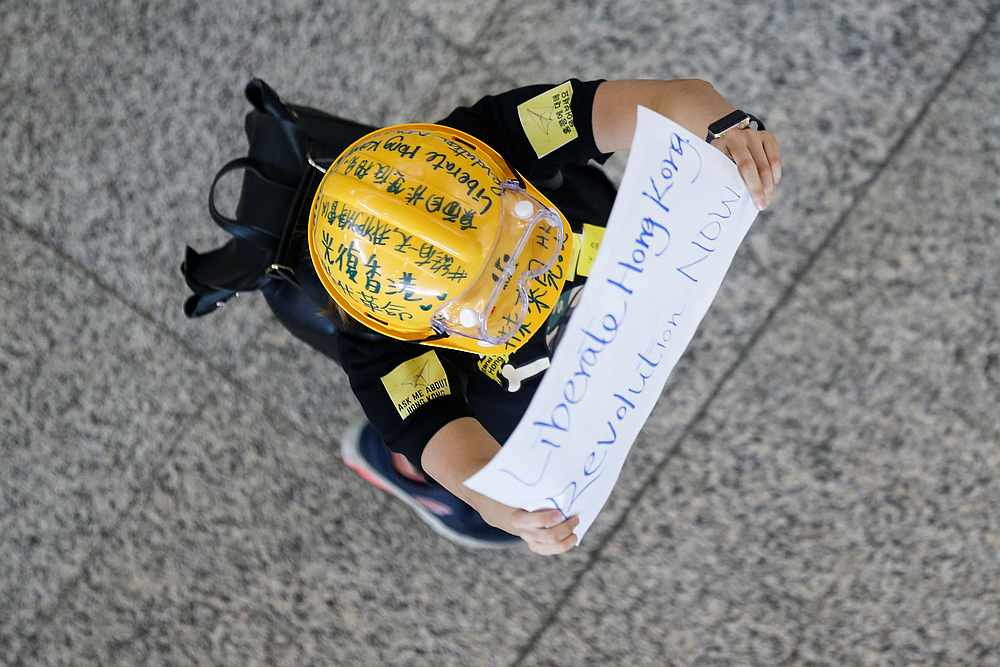 An anti-extradition bill protester holds up a placard for arriving travellers during a protest at the arrival hall of Hong Kong International Airport in Hong Kong August 9, 2019. u00e2u20acu201d Reuters pic