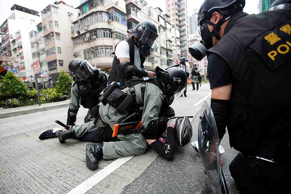 Police officers subdue an anti-government protester near Sham Shui Po police station in Hong Kong August 11, 2019. u00e2u20acu201d Reuters pic
