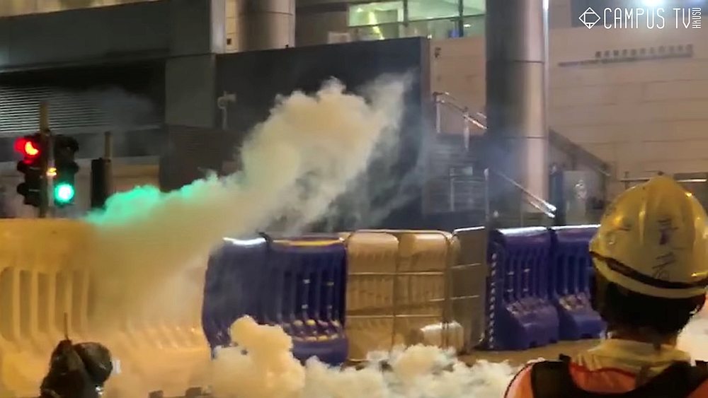 Smoke from a tear gas canister that was thrown back by protesters at Wan Chai police headquarters in Hong Kong, August 5, 2019. u00e2u20acu201d Campus TV, HKUSU image via Reuters 