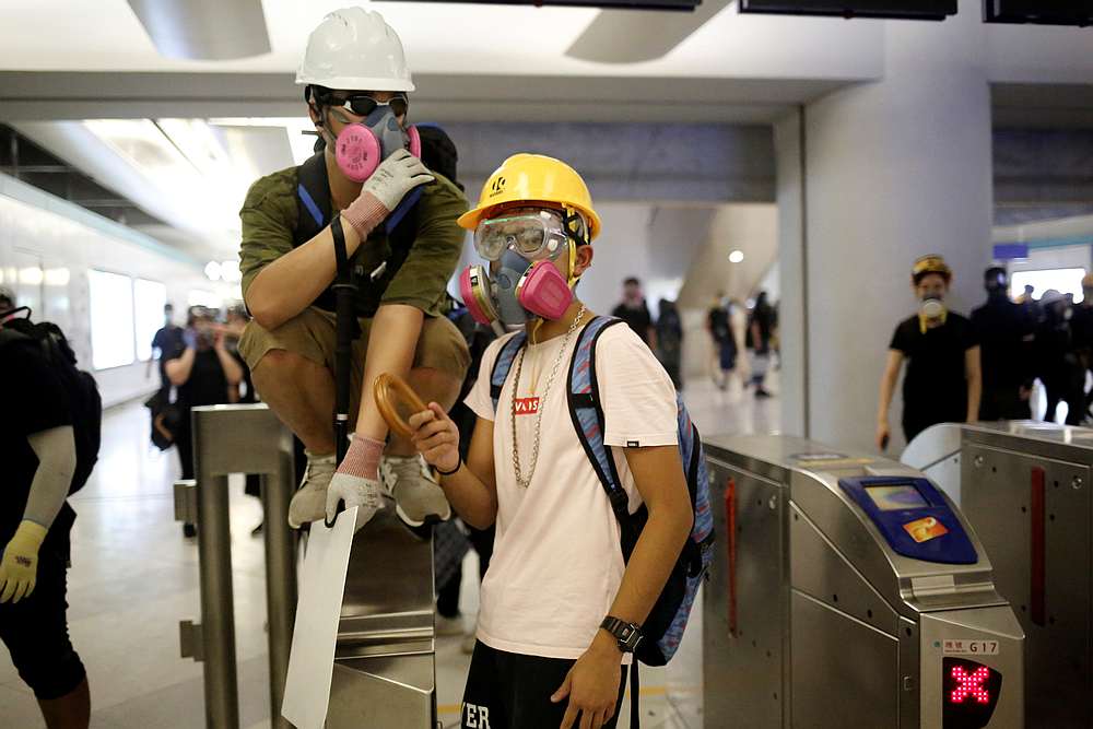 Protesters stand around a fare gate inside Yuen Long MTR station, New Territories, Hong Kong August 21, 2019. u00e2u20acu201d Reuters pic