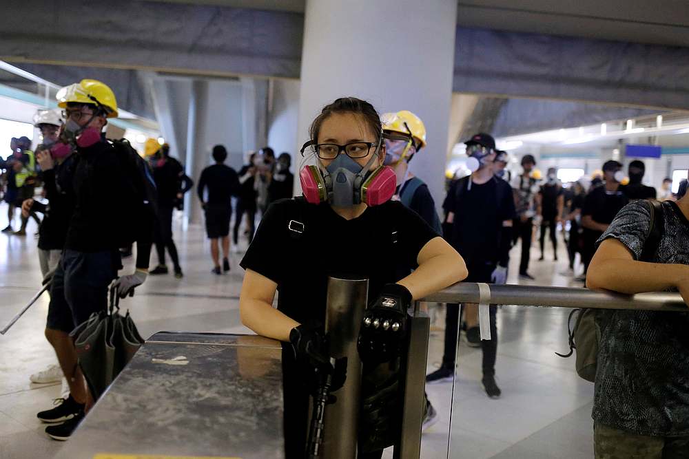 Protesters stand around a fare gate inside Yuen Long MTR station, the scene of an attack by suspected triad gang members a month ago, in Hong Kong August 21, 2019. u00e2u20acu201d Reuters pic