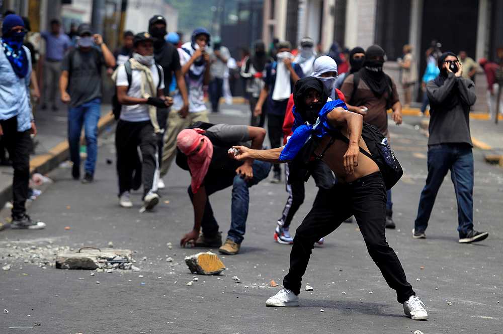 Demonstrators throw stones back to riot police during a protest against Honduran President Juan Orlando Hernandez, in Tegucigalpa, Honduras August 6, 2019. u00e2u20acu201d Reuters pic
