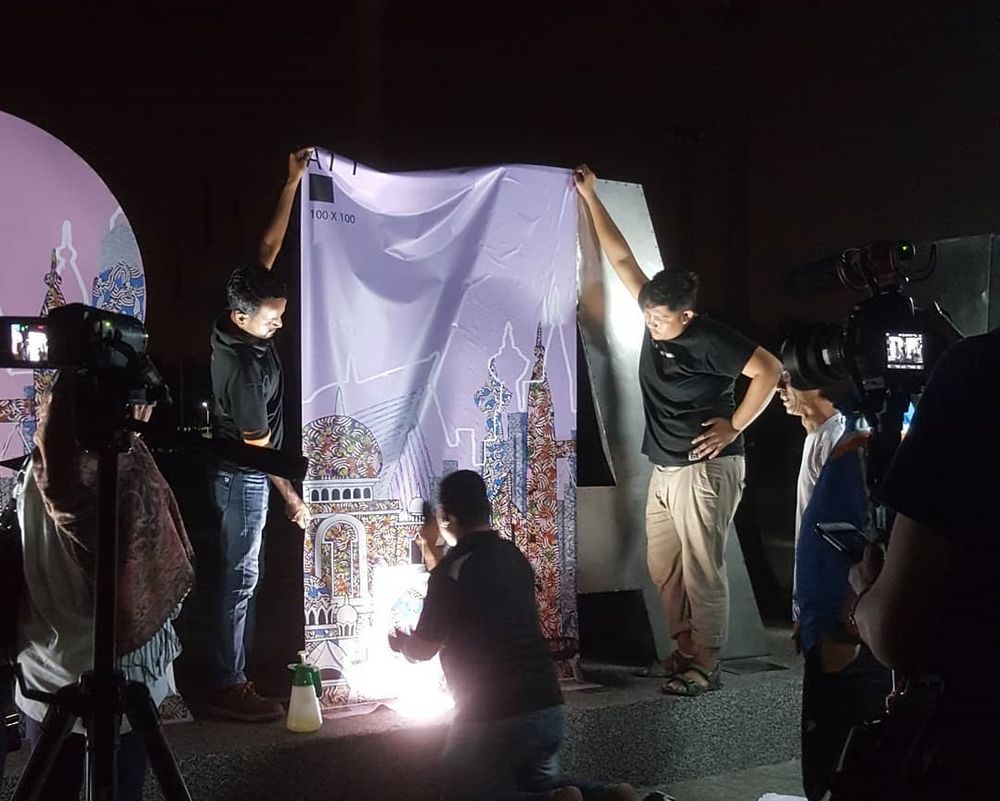 Workers at Putrajaya installing Jamila’s artwork.