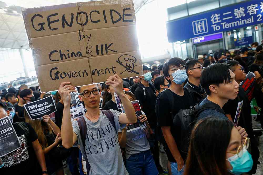Hong Kong native and Australian resident Jason Tse holds a placard during a protest at the airport in Hong Kong August 12, 2019. u00e2u20acu201d Reuters pic
