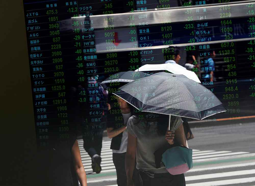 Passersby are reflected on a stock quotation board outside a brokerage in Tokyo, Japan August 6, 2019.u00e2u20acu201d Reuters pic