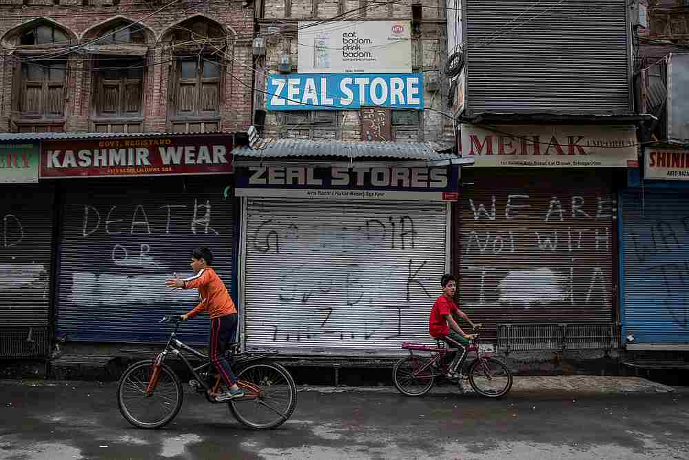 Kashmiri boys cycle in an empty street during restrictions after the scrapping of the special constitutional status for Kashmir by the government, in Srinagar August 14, 2019. u00e2u20acu201d Reuters pic