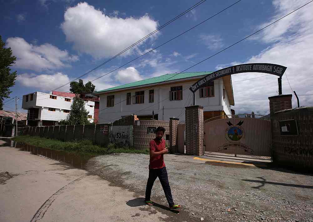 A Kashmiri man walks past a school in Srinagar August 19, 2019. u00e2u20acu201d Reuters pic