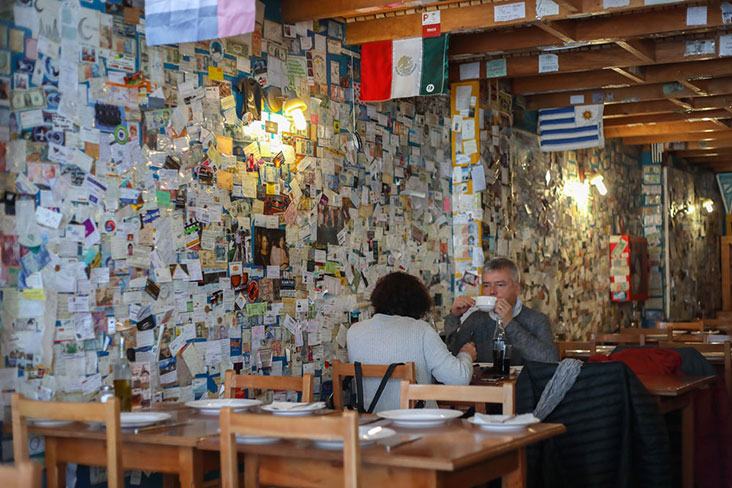 A wall of postcards and letters from around the world.