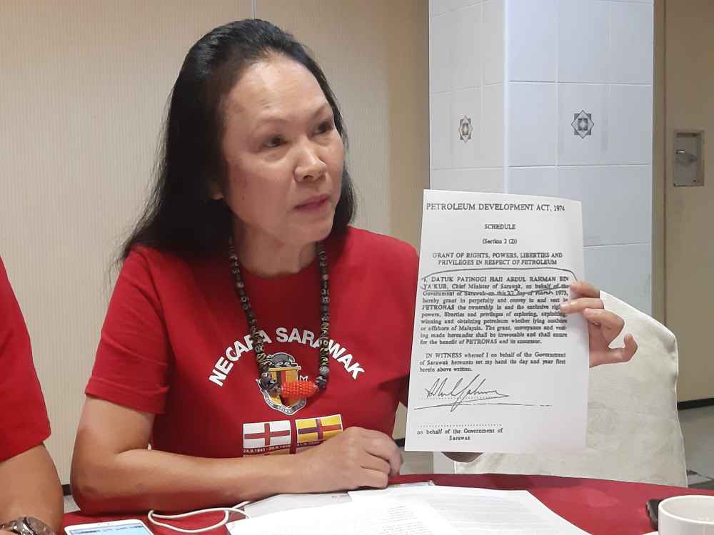 STAR president Lina Soo showing an agreement signed by former Chief Minister the late Tun Abdul Rahman Ya'kub granting in perpetuity the rights, powers, liberties and privileges in respect of petroleum , August 22, 2019. u00e2u20acu2022 Picture by Sulok Tawie