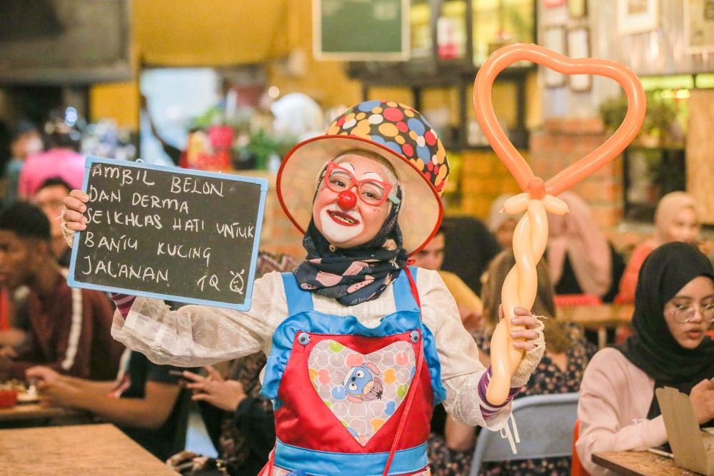 Nazirah Abd Rahman, widely known as u00e2u20acu02dcMama Pinkyu00e2u20acu2122, uses proceeds from her part-time job at Konda Kondi, Ipoh  to care for stray animals. u00e2u20acu201d Picture by Farhan Najib