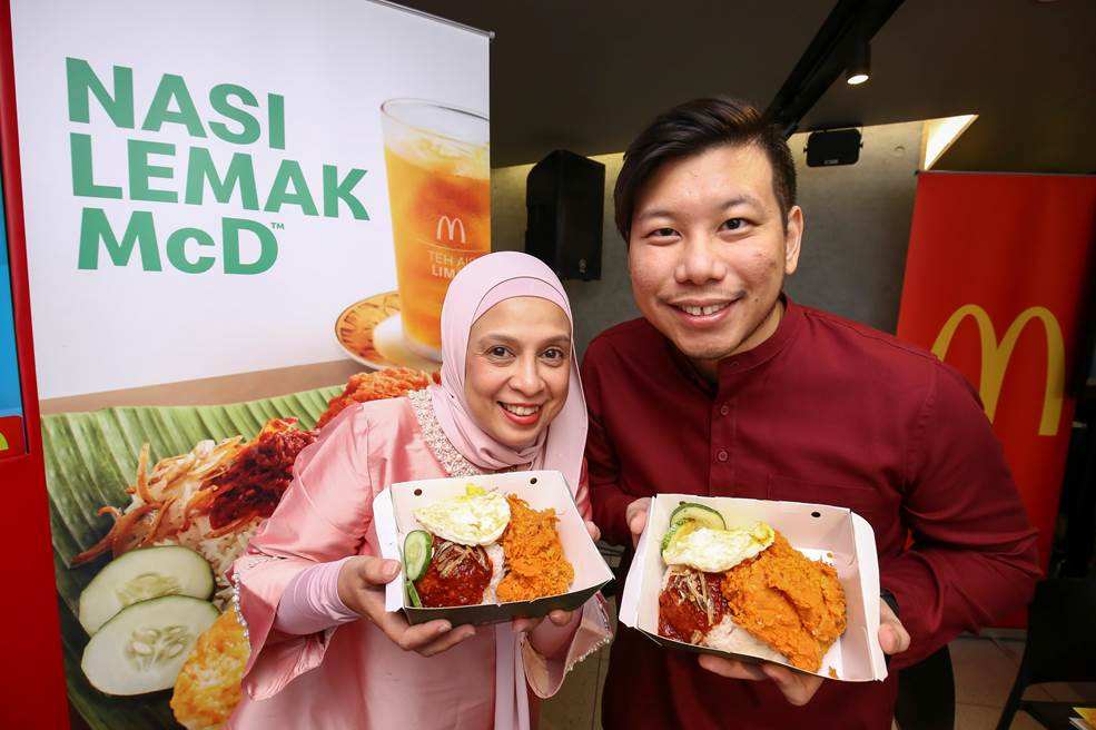 Melati (left) and McDonald’s Malaysia marketing director Eugene Lee showing off the new Nasi Lemak McD meal. — Picture courtesy of McDonald’s Malaysia