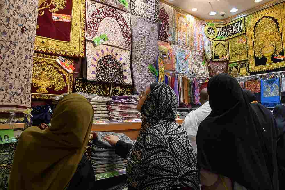 Muslim pilgrims shop prayer rugs at a market in the Saudi holy city of Mecca August 6, 2019. u00e2u20acu201d AFP pic