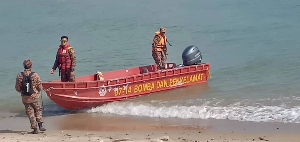 A Fire and Rescue Department boat that is part of the search and rescue (SAR) operation for the missing Singapore couple in Mersing August 13, 2019. u00e2u20acu201d Picture courtesy of Malaysian Maritime Enforcement Agency (MMEA) 