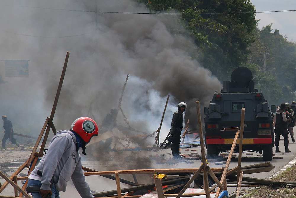 Police officers stand guard during a protest in Mimika, Papua, Indonesia August 21, 2019. u00e2u20acu201d Antara Foto/Sevianto Pakiding pic via Reuters