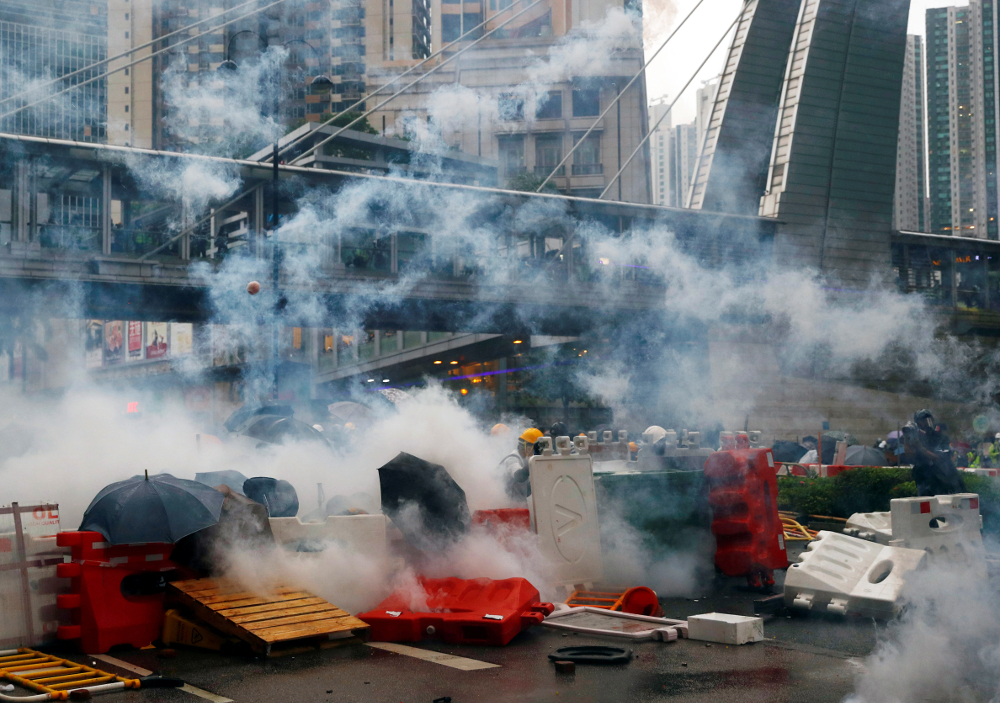 Demonstrators stand behind barricades, surrounded by tear gas, during a protest in Tsuen Wan, in Hong Kong August 25, 2019. u00e2u20acu201d Reuters pic