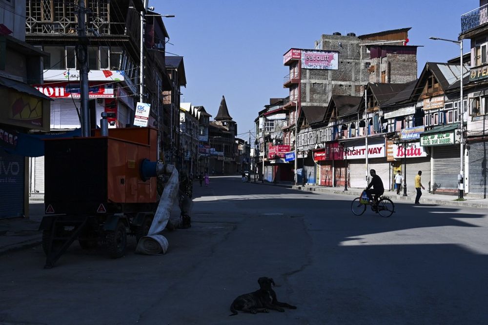 A man rides on a bicycle near closed shops in Srinagar on August 22, 2019. u00e2u20acu201d AFP pic