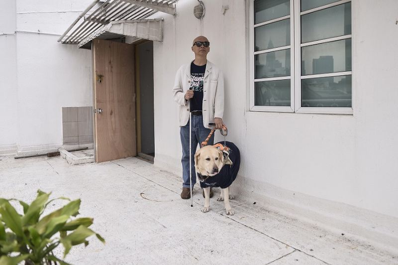  Chan with his loyal guide dog LaShawn. u00e2u20acu2022 Picture by Miera Zulyana