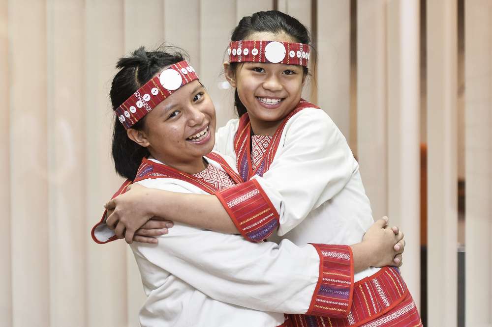 It’s up to indigenous children like Xiao Yun (left) and Xiao Lin to preserve their culture for the next generation. 