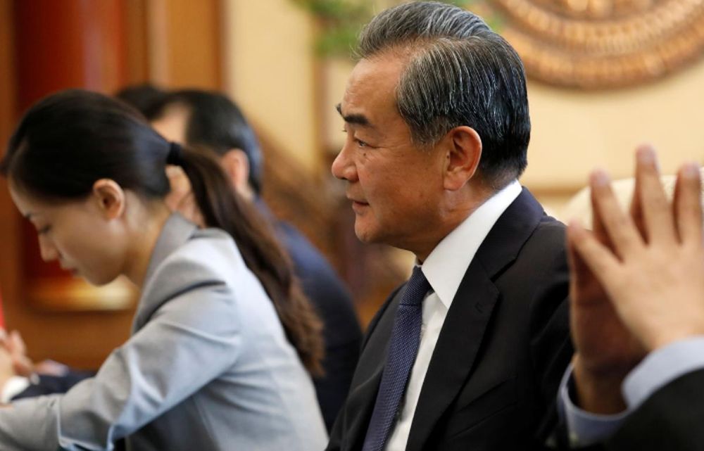 Chinese Foreign Minister Wang Yi (right) listens to Minister for the Office of the State Counsellor of Myanmar Kyaw Tint Swe (not pictured) at the Diaoyutai State Guesthouse in Beijing, August 27, 2019. u00e2u20acu201d How Hwee Young/Pool via Reuters