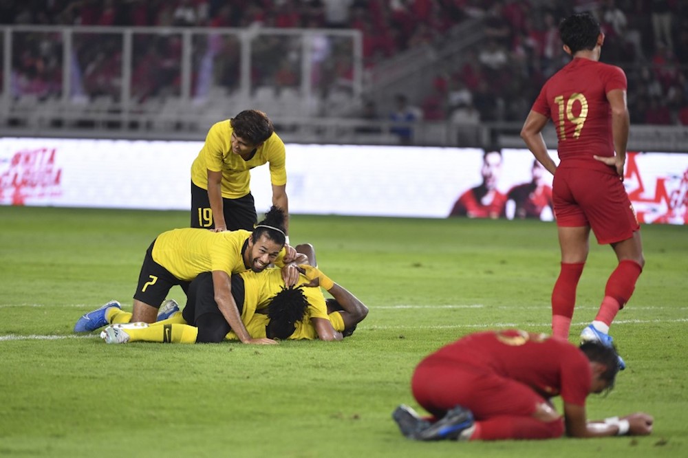 Malaysia’s players celebrate a goal as Indonesia’s players react during the Fifa World Cup preliminary qualification round 2 at Gelora Bung Karno stadium in Jakarta September 5, 2019. — AFP pic