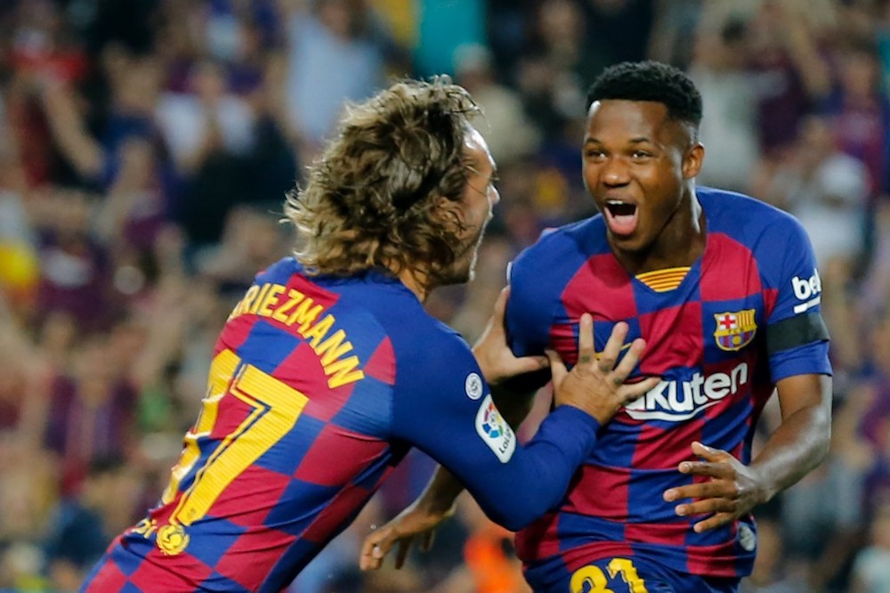 Barcelonau00e2u20acu2122s Ansu Fati is congratulated by Antoine Griezmann after scoring a goal during the La Liga match with Valencia at Camp Nou stadium in Barcelona September 14, 2019. u00e2u20acu201d AFP pic