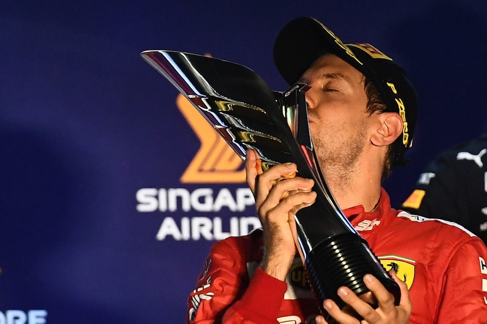 Ferrariu00e2u20acu2122s Sebastian Vettel kisses the trophy on the podium after winning the Formula One Singapore Grand Prix night race September 22, 2019. u00e2u20acu201d AFP pic