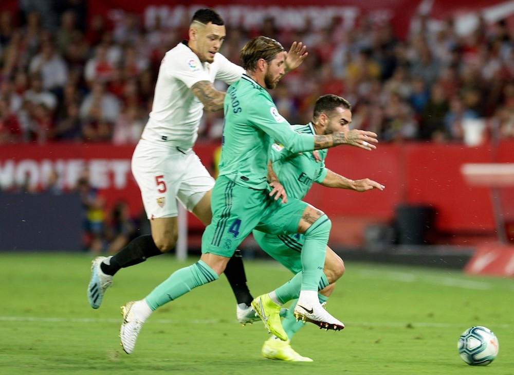 Real Madridu00e2u20acu2122s Sergio Ramos and Dani Carvajal fight for the ball with Sevillau00e2u20acu2122s Lucas Ocampos during their La Liga match at Ramon Sanchez Pizjuan in Seville September 22, 2019. u00e2u20acu201d AFP pic