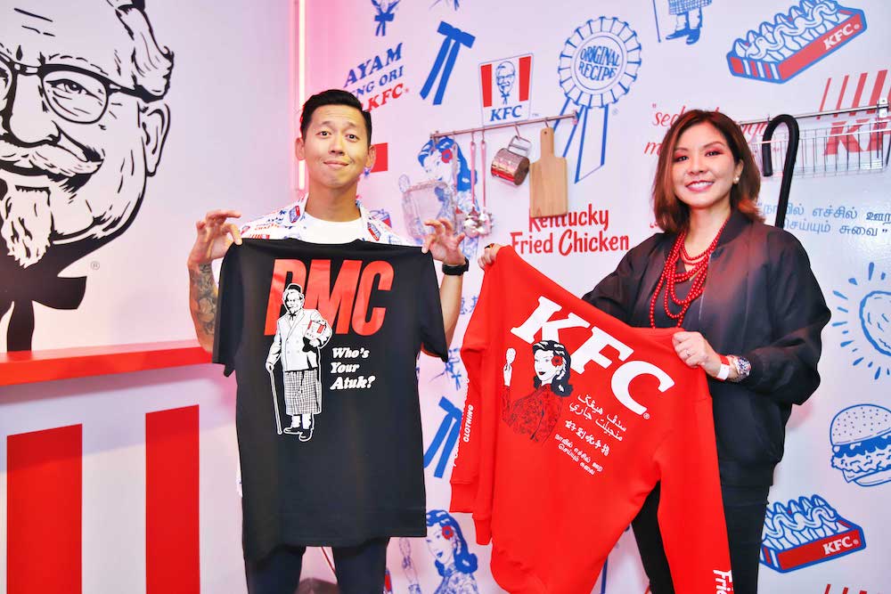 Pestle & Mortar Clothing’s co-founder and creative director Hugh Koh and KFC Malaysia’s chief marketing officer Angelina Villanueva with a few items from the collection. — Picture courtesy of KFC Malaysia.