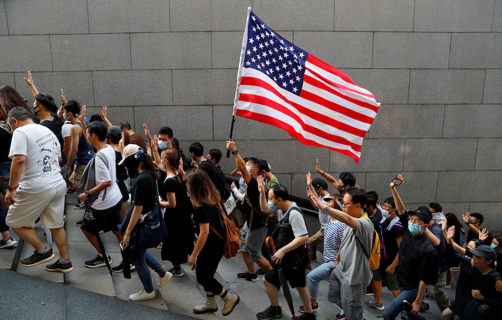Protesters hold up five fingers and a US flag during a rally to the US Consulate General in Hong Kong September 8, 2019. u00e2u20acu201d Reuters pic