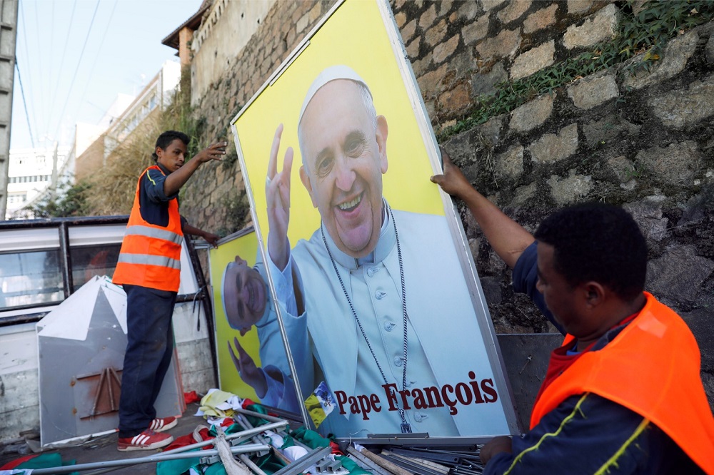 Municipal workers hold the portrait of Pope Francis ahead of his visit to Antananarivo, Madagascar August 27, 2019. u00e2u20acu201d Reuters pic