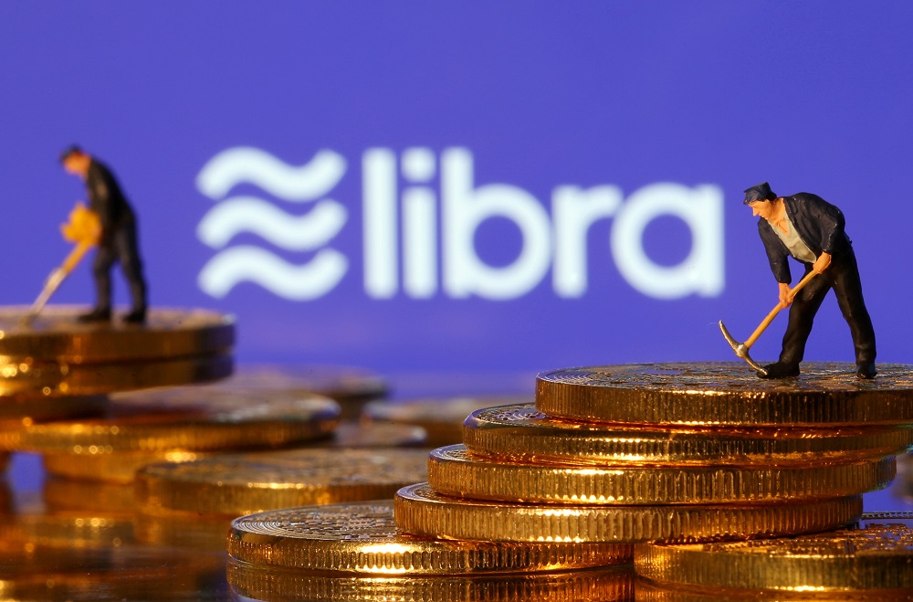 Small toy figures are seen on representations of virtual currency in front of the Libra logo in this illustration picture June 21, 2019. u00e2u20acu201d Reuters pic