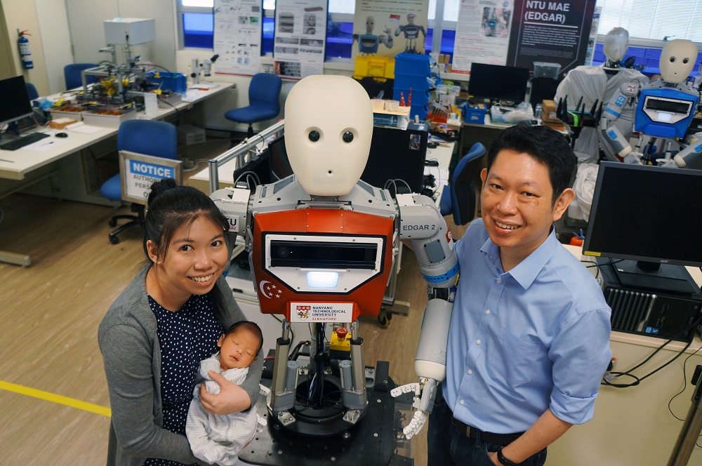 Singaporean robot creator Wong Choon Yue, his wife Pang Wee Ching and son Gabriel pose with their robot named EDGAR at a laboratory in Singapore September 8, 2019. u00e2u20acu201d Picture by Wong Choon Yue/Handout via Reuters