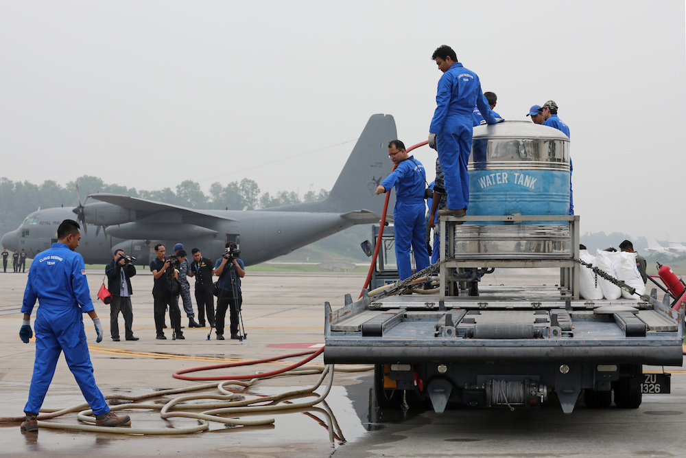 Members of the Malaysian Air Force prepare to carry out a cloud seeding operation at a military airbase in Subang September 19, 2019. — Reuters pic