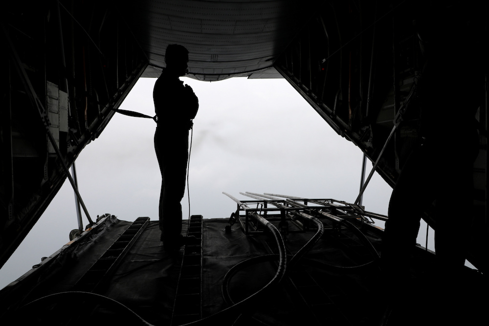 A Malaysian Air Force officer observes the progress of saltwater release in a military aircraft during a cloud seeding operation in Subang September 19, 2019. u00e2u20acu201d Reuters pic
