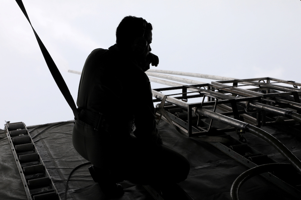 A Malaysian Air Force officer observes the progress of saltwater release in a military aircraft during a cloud seeding operation in Subang September 19, 2019. u00e2u20acu201d Reuters pic