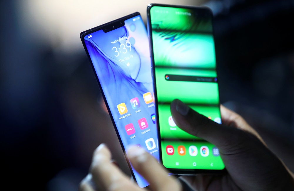 A person holds two new Huawei Mate 30 smartphones at the Convention Centre in Munich September 19, 2019. u00e2u20acu201d Reuters pic