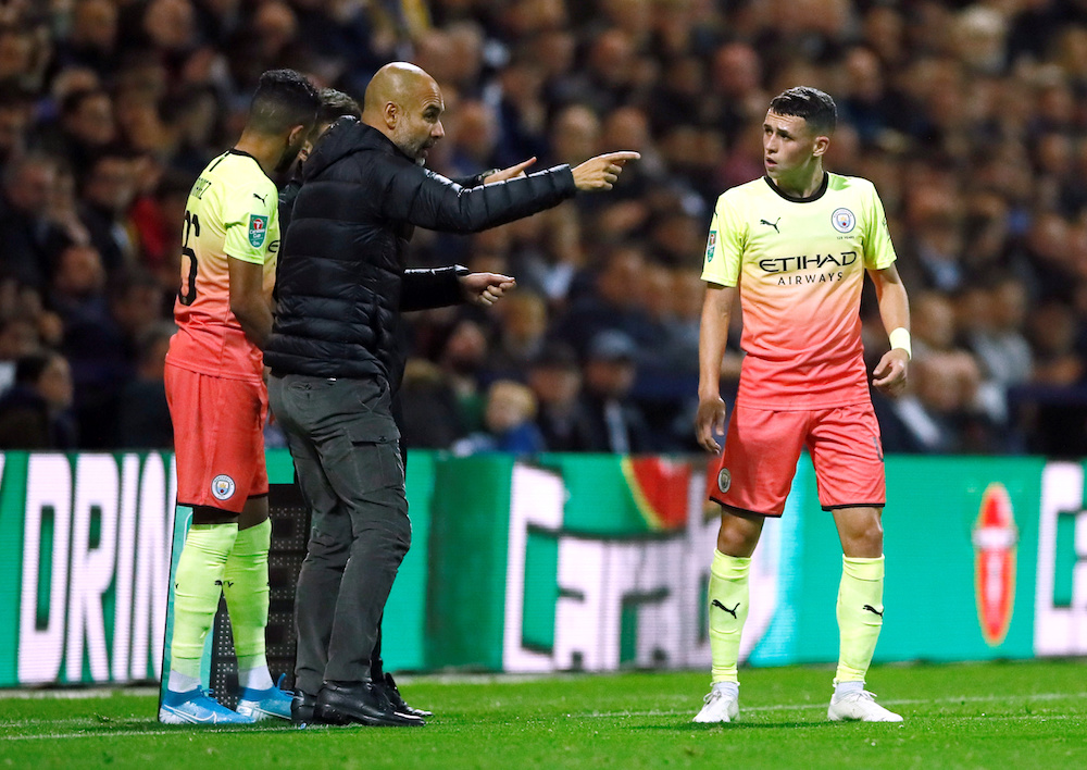 Manchester City manager Pep Guardiola speaks to Phil Foden during the third-round League Cup match with Preston North End at Deepdale in Preston September 24, 2019. u00e2u20acu201d Action Images pic via Reuters