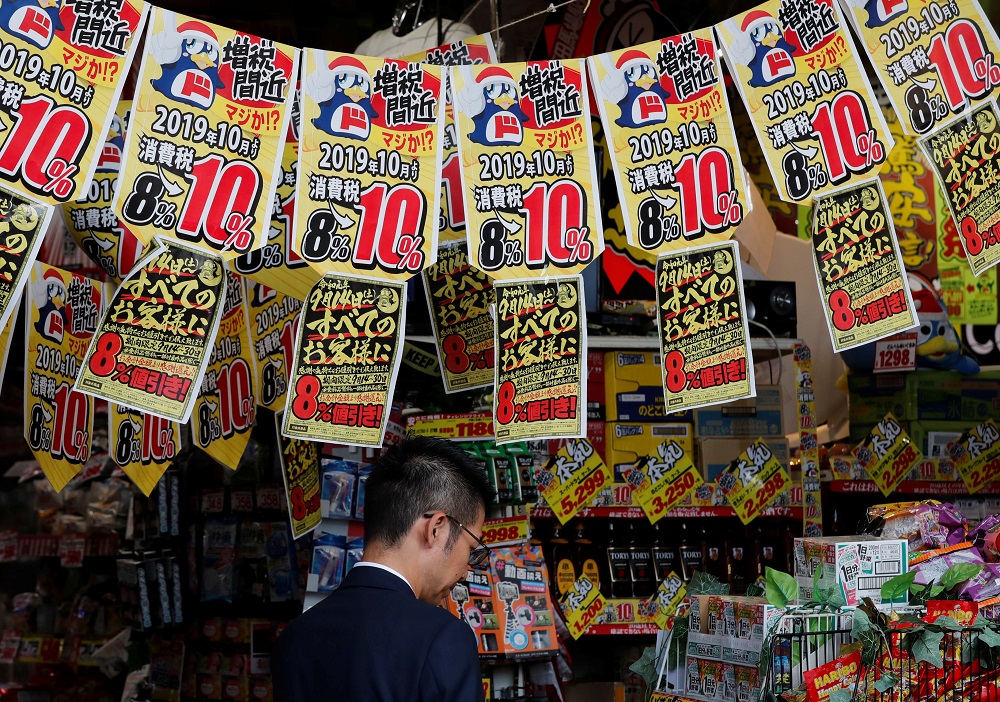 A man chooses goods underneath banners notifying the rise in the national sales tax at a store in Tokyo September 25, 2019. u00e2u20acu201d Reuters pic 