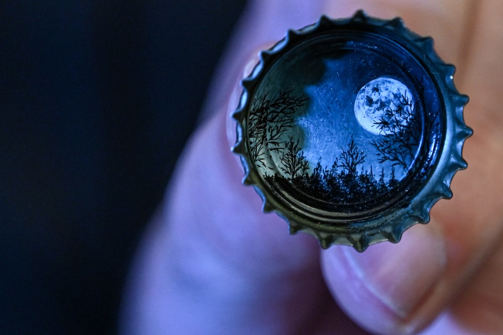 A picture taken on August 23, 2019 shows a moon landscape painted on a bottle cap by Turkey's micro artist Hasan Kale in Istanbul. u00e2u20acu201d AFP pic