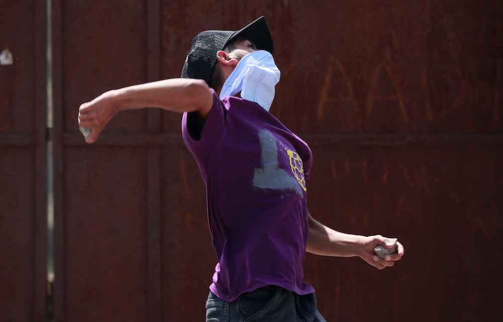 A protester throws a stone towards Indian Police during a protest after the funeral of Asrar Ahmed Khan, who died on Tuesday night after succumbing to wounds during a protest on August 6, in Srinagar, September 4, 2019. u00e2u20acu201d Reuters pic