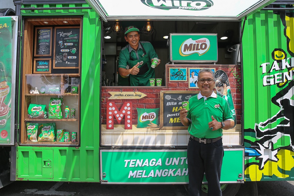 Noorhishan Ghazali, 43, and Mohd Rashid Abdul Wahab, 64, have been serving Milo for a large part of their lives, but never get tired of putting smiles on the young kidu00e2u20acu2122s faces when they serve them a cup. u00e2u20acu201d Pictures by Yusof Mat Isa