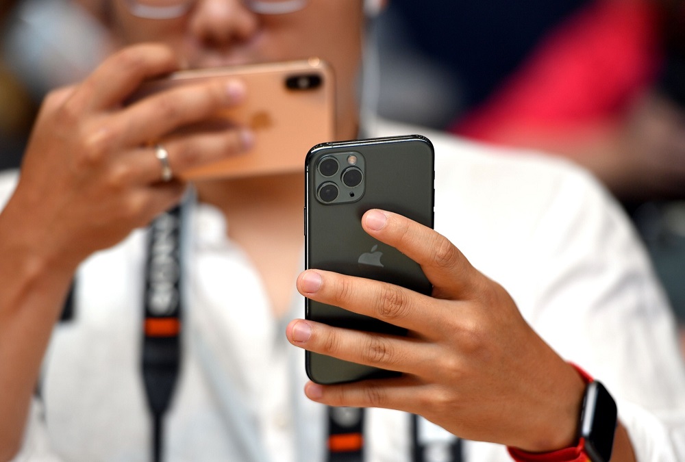 A man takes a photo of the new Apple 11 Pro during an Apple product launch event at Apple’s headquarters in Cupertino September 10, 2019. — AFP pic
