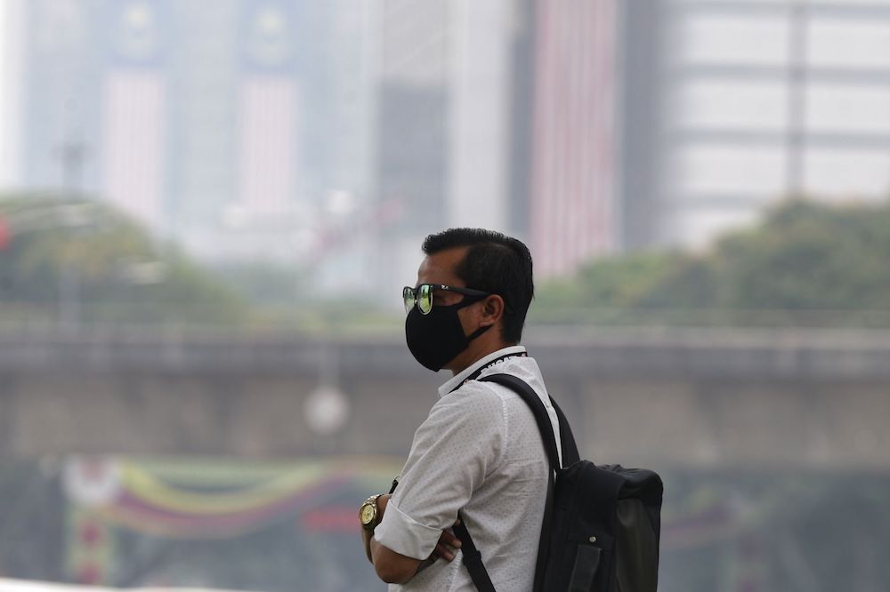 A man wears a mask as haze blankets Kuala Lumpur September 12, 2019. u00e2u20acu201d Picture by Ahmad Zamzahuri