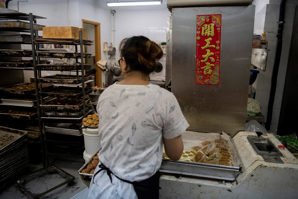 A baker packaging mooncakes, adorned with popular slogans from recent pro-democracy protests, ahead of the annual mid-autumn festival in Hong Kong. u00e2u20acu201d AFP pic