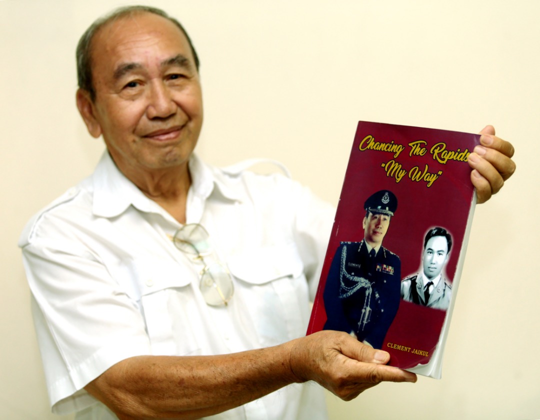 Datuk Clement Jaikul with his book. u00e2u20acu201d Picture by Julia Chan
