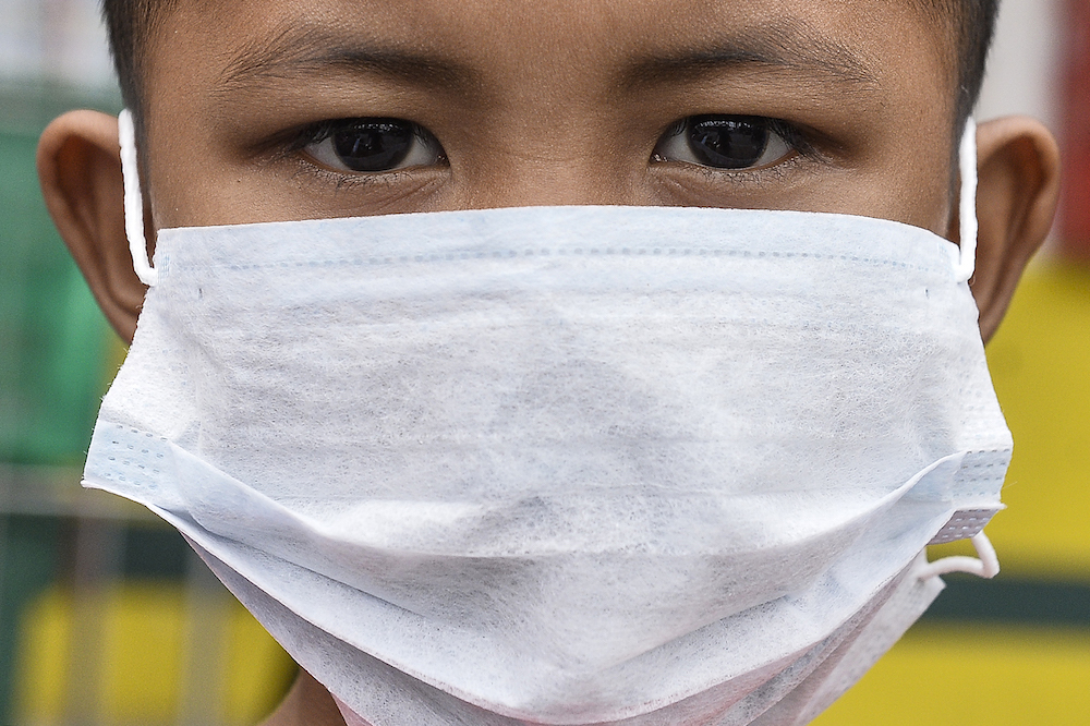 A boy wears a face mask in Klang September 18, 2019. u00e2u20acu201d Picture by Miera Zulyana