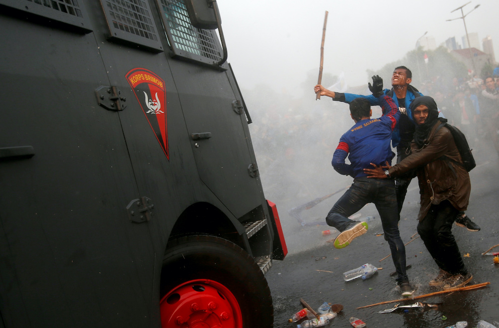 Riot police deploy a water cannon as protesters attack a police vehicle during university students' protest outside the Indonesian Parliament in Jakarta September 24, 2019. u00e2u20acu201d Reuters pic
