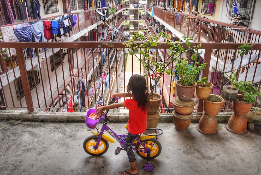 A girl rides a bicycle in the corridor of a low-cost flat in Kuala Lumpur September 29, 2019. — Picture by Ahmad Zamzahuri